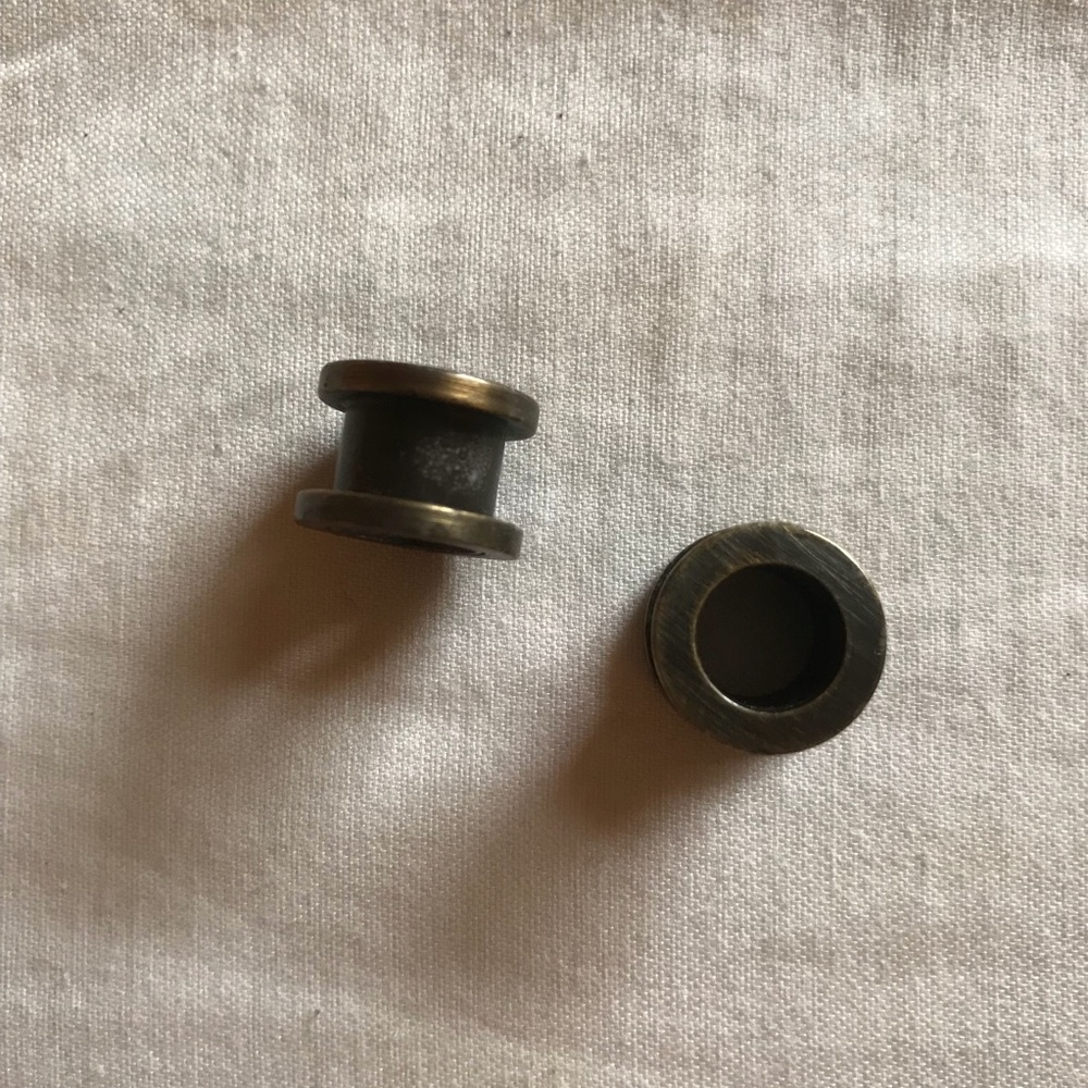 Rustic metal eyelet plugs
